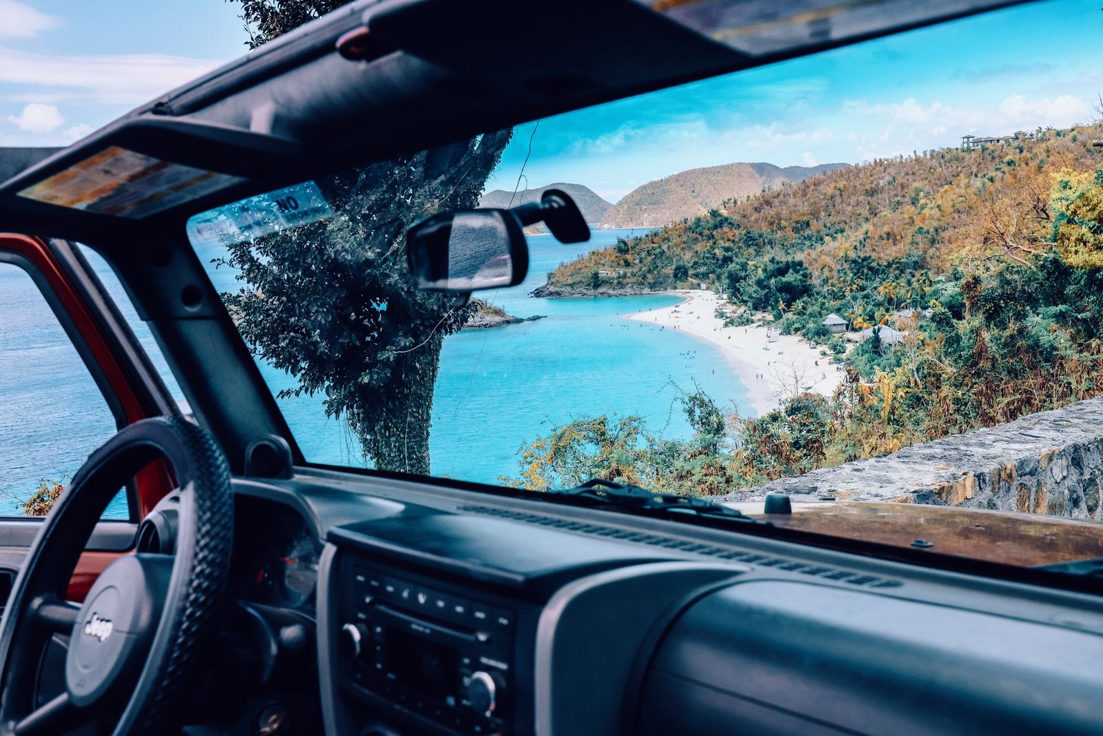 Looking through the windshield of an open Jeep at Trunk Bay below, on a drive along the North Shore of St. John, Virgin Islands